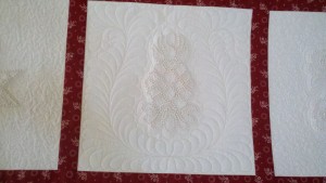 Custom quilting around pineapple candlewick block